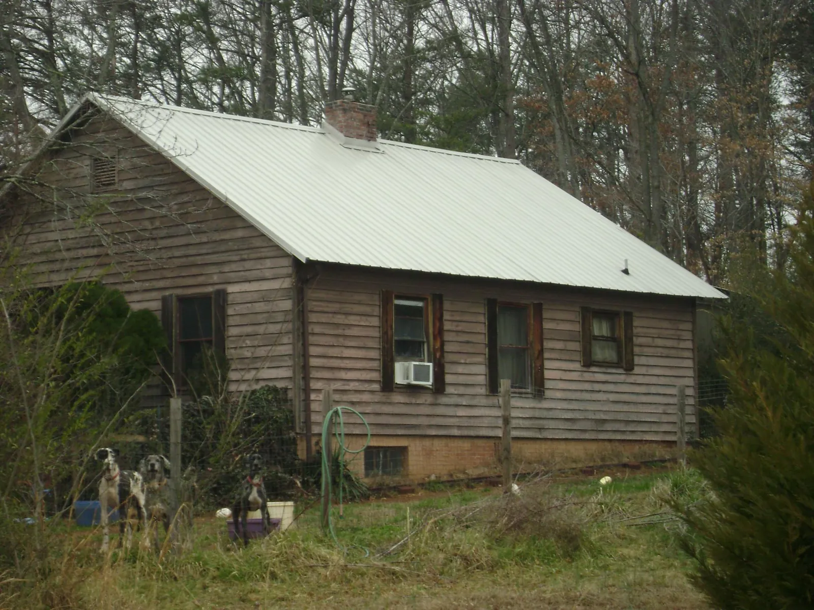 White metal roof on an old wood sided farmhouse, from a Metal Roof Installation job in Elizabethton